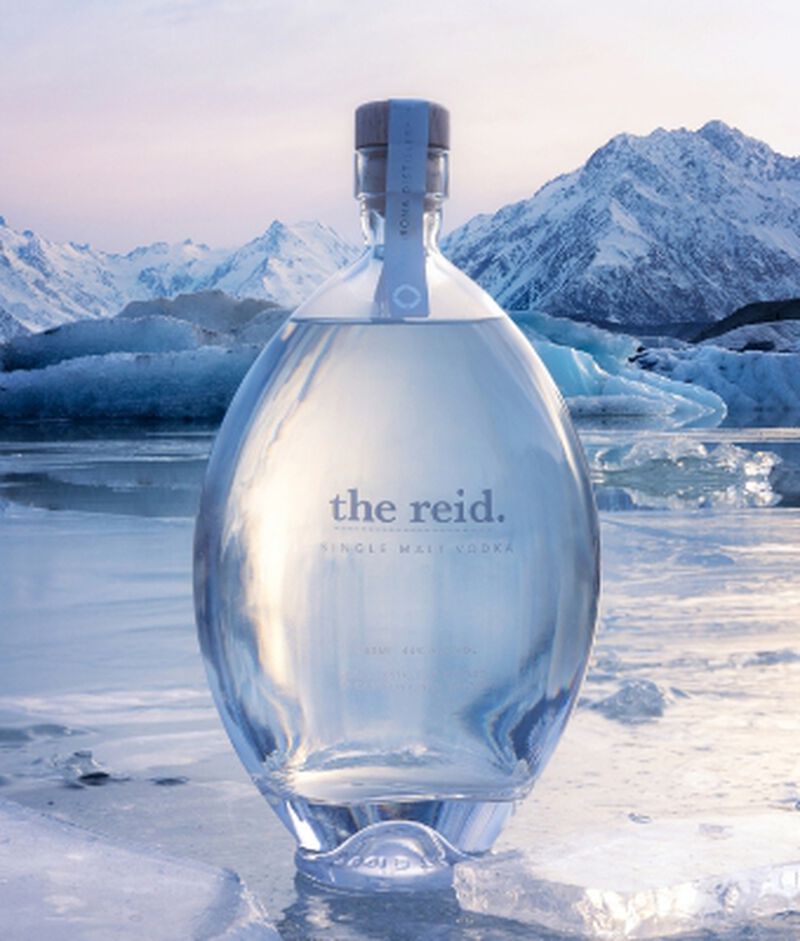 A bottle of The Reid Single Malt Vodka in front of a snow covered mountain